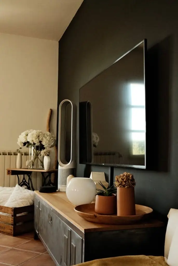 Stylish living room interior with a mounted TV, modern decor elements, and cozy atmosphere.